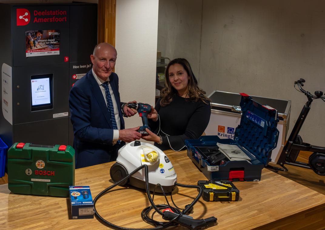 2 mensen die een deelstation uitlichten